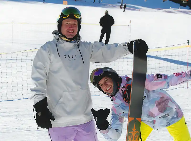Two snowboarders on a snowy slope.